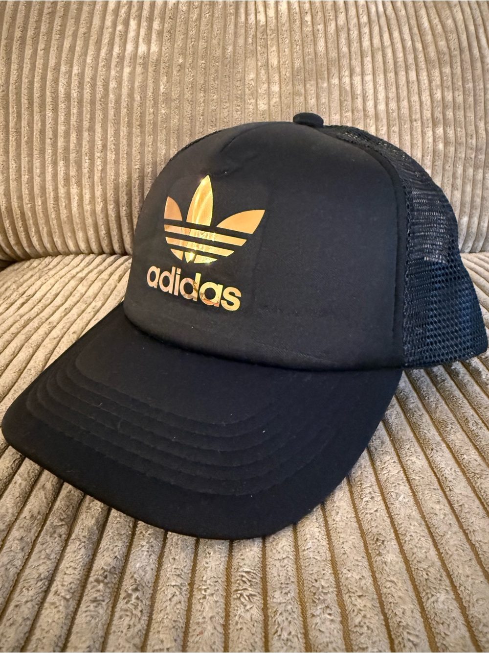 Black Mesh Trucker Hat with Gold Trefoil Sports Logo Adjustable